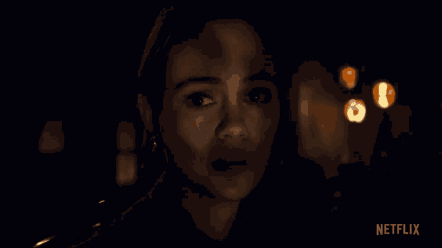 a close up of a woman 's face with netflix written on the bottom right