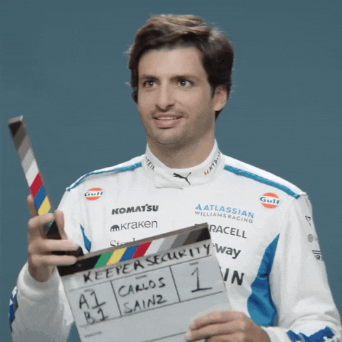 a man holding a clapper board that says " keeper security way "
