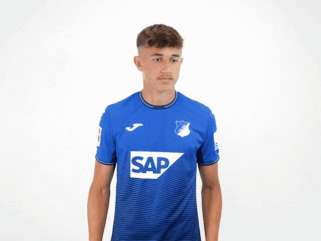 a young man in a blue shirt with the word sap on it