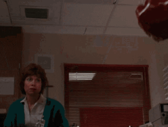 a man in a lab coat and tie with blood on his face