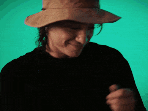 a close up of a person wearing a hat with the letter o on it