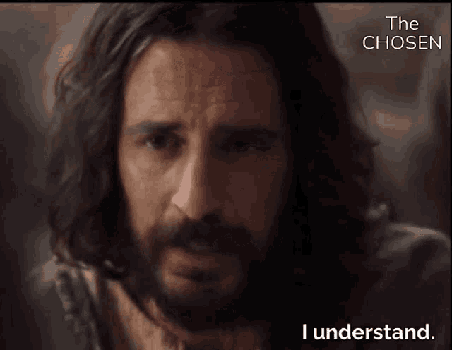 a man with long hair and a beard is talking about the chosen