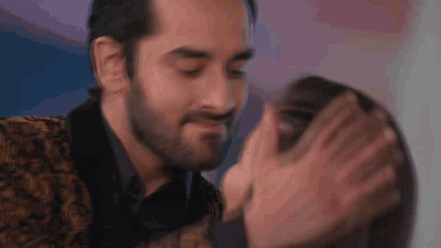 a man is kissing a woman on the cheek