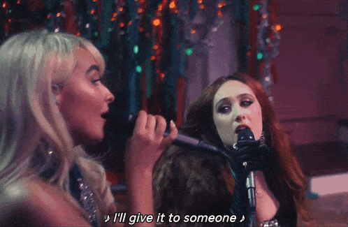 a woman singing into a microphone with the words i 'll give it to someone