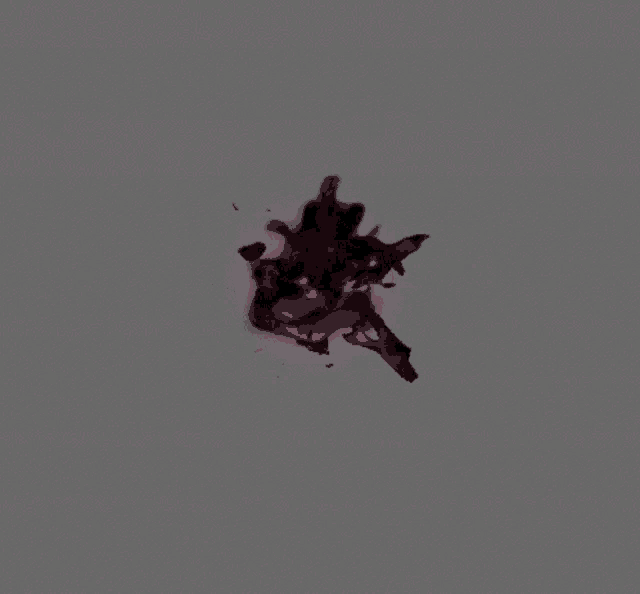 a gray background with a red glowing object floating in the air