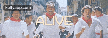 a group of men wearing white shirts and red scarves are running down a street with the word alive above them