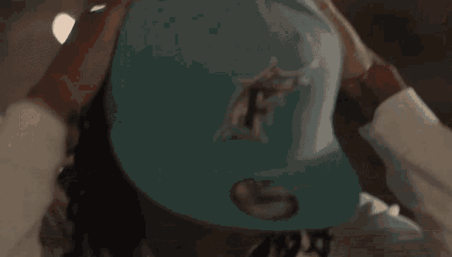 a man wearing a hat that has the letter fn on it