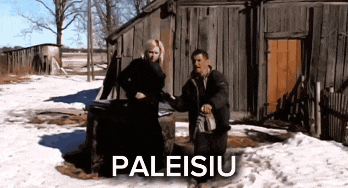 a man and a woman are standing in front of a wooden building and the word paleisitu is on the bottom