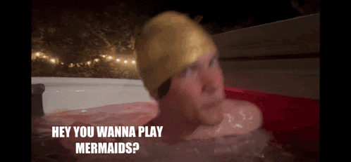 a man in a hot tub with the words " hey you wanna play mermaids " above him