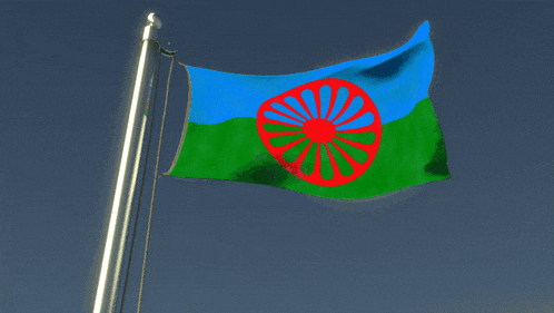 a blue green and red flag with a red wheel in the middle