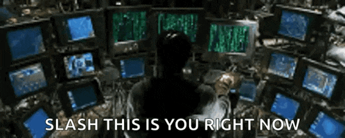 a man is sitting in front of a bunch of computer monitors with the words " slash this is you right now " on the bottom