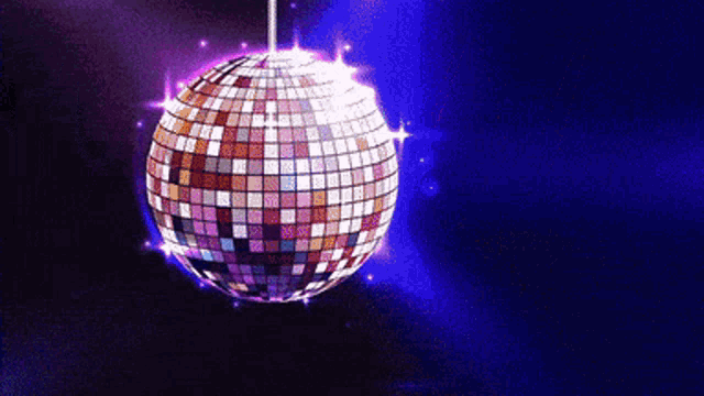 a disco ball is hanging from a string on a dark blue background