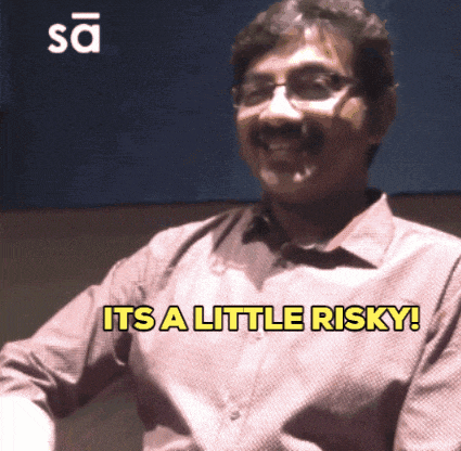 a man with glasses says it 's a little risky in yellow letters