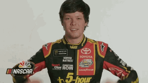 a man in a nascar uniform is standing in front of a white background