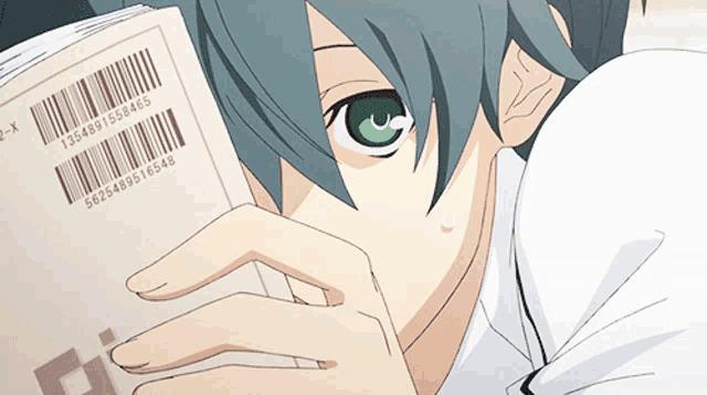 a close up of a person holding a book with a barcode