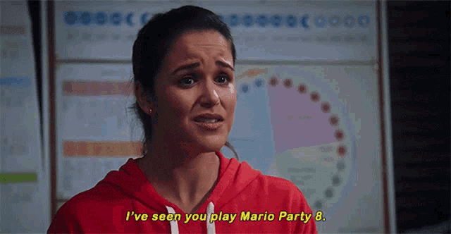 a woman in a red hoodie is saying i 've seen you play mario party 8