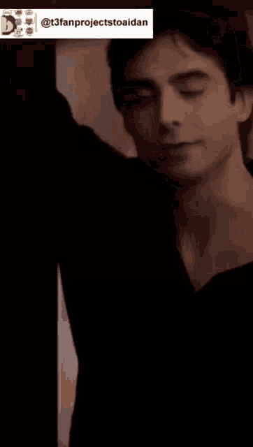 a man in a black shirt is smiling with a sticker that says @t3fanprojectstoaidan
