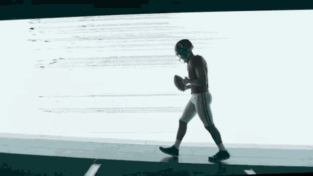 a person is walking in a dark room with a white background