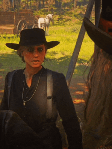 a woman wearing a black hat and suspenders is standing in a field