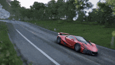 a red sports car is driving down a road in a video game