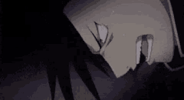 a close up of a person 's face in a dark room with a tear coming out of his eye .