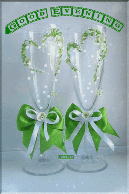 two wine glasses with green bows and the words good evening on the top