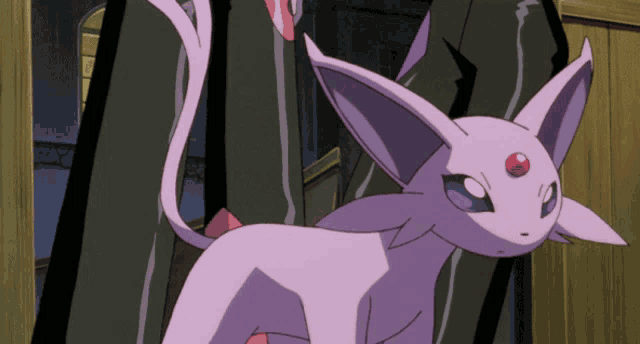 a purple cat with a red spot on its forehead