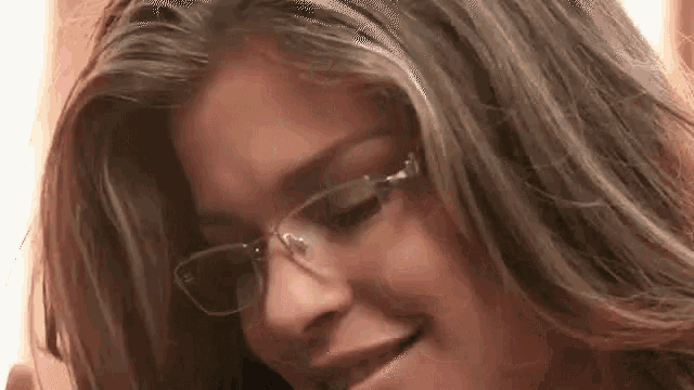 a close up of a woman wearing glasses .