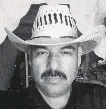 a man with a mustache wearing a straw hat