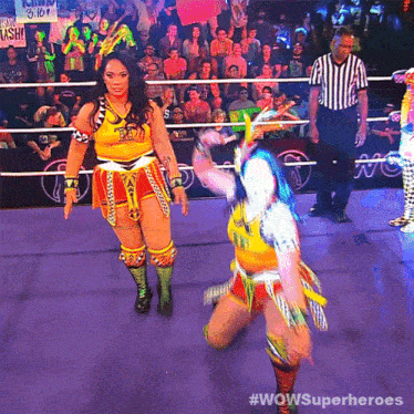 two women in a wrestling ring with the words wowsuperheroes written on the bottom