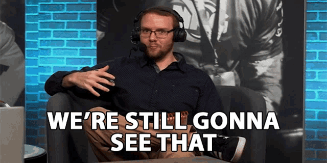 a man wearing headphones and glasses is sitting in a chair and saying we 're still gonna see that