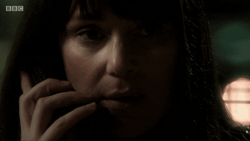 a close up of a woman talking on a cell phone with bbc written on the bottom right