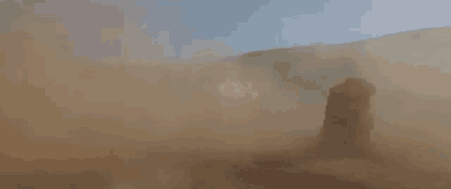a person is standing in the middle of a dust storm in the desert .