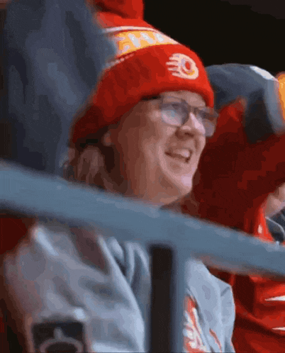 a woman wearing glasses and a red hat with a flame on it