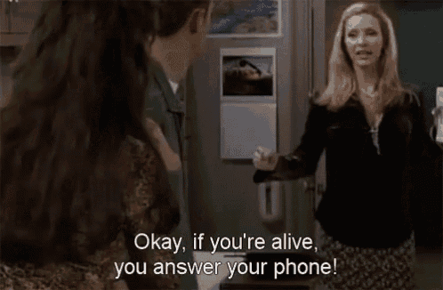 two women are standing next to each other and one of them is saying `` okay , if you 're alive you answer your phone ''
