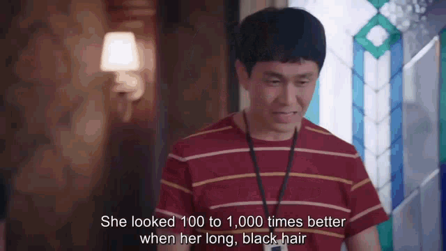 a man in a red and yellow striped shirt is talking about a woman 's long black hair .