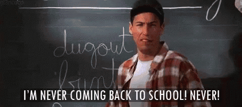 a man standing in front of a blackboard with the words i 'm never coming back to school never written on it