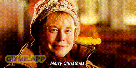 a woman is wearing a hat and scarf and says merry christmas .