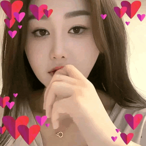 a woman wearing a necklace with a letter c on it