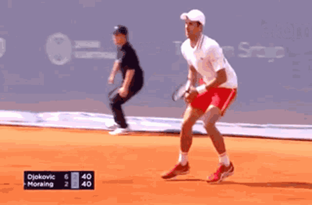a tennis player is laying on the ground and the score is 40 to 2