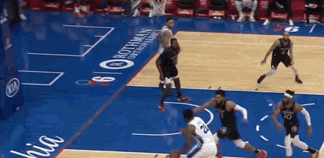 a basketball game is being played on a court that has a kia ad on it