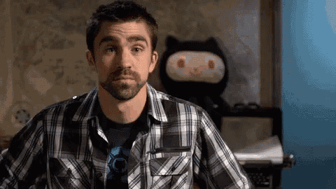 a man with a beard is wearing a plaid shirt .