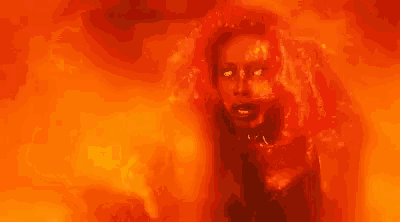 a close up of a woman 's face surrounded by fire .