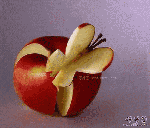 a red apple with a butterfly cut out of it and the website www.hhtu.com