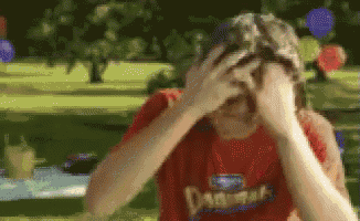 a pixelated image of a person wearing a red shirt that says ' dad ' on it
