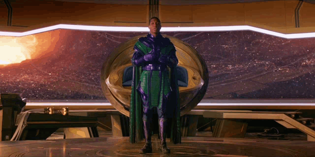 a man in a purple cape stands in front of a large window