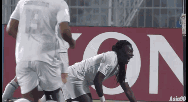 a soccer player in a white jersey with the number 19 on it