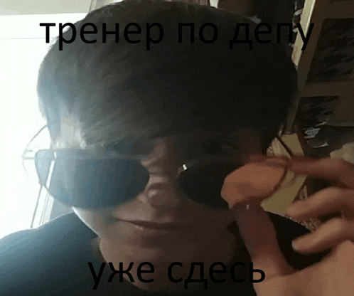 a man wearing sunglasses is talking on a cellphone