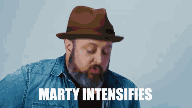 a man with a beard is playing a guitar with the words marty intensifies below him