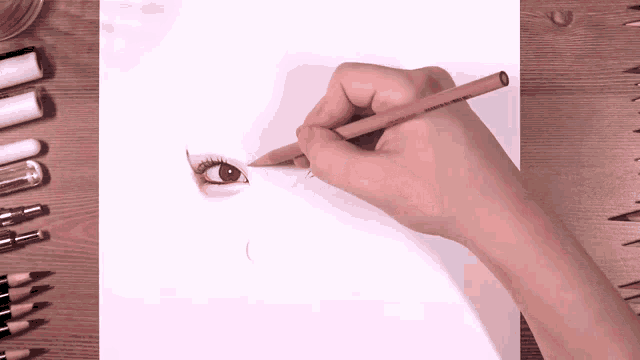 a person drawing a woman 's eye with a pencil that says prismacolor